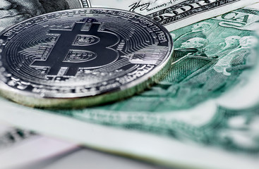 Symbolic coins of bitcoin on banknotes of  dollars. 