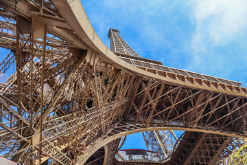Eiffel Tower against blue sky with clouds in Paris, France. April 2019