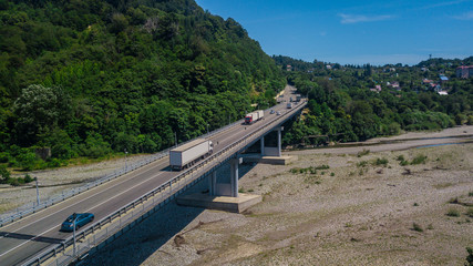 Fototapeta na wymiar Aerial view of suv truck traffic on bridge, 2 lane road with cars