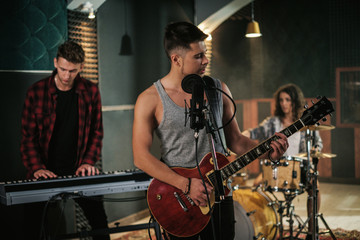 Obraz premium Music band having rehearsal in a studio