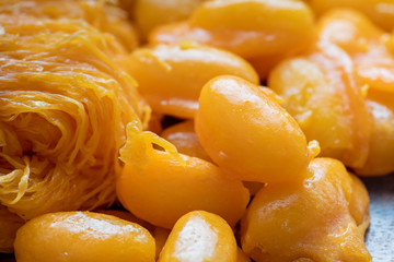 Close up of famous Thai dessert, Thongyod or sweety gloden drop or egg yoke fudge balls, Foythong or sweet egg floss and Medkanhoon made of egg and mung beans