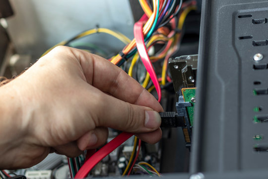 Hands of the technician repairing a computer. Hardware instalation.