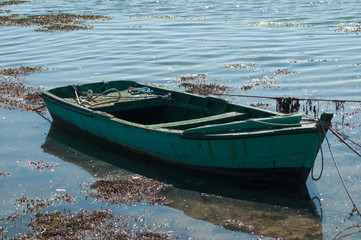 Closeup of wooden small boat floating on the river
