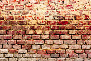 Texture of a brick wall with cracks and scratches which can be used as a background