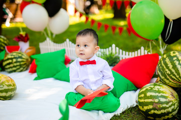 Fototapeta na wymiar Happy child with watermelon. Happy Infant smiling. Little boy playing in the garden biting a slice of watermelon