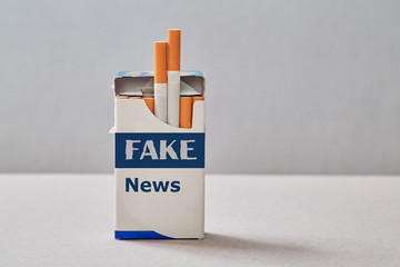 Fake news, disinformation or false information and propaganda concept. A pack of cigarettes with an...