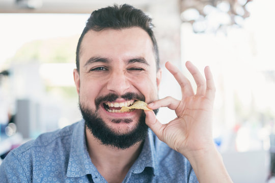 Man In Restaurant Eating Chips