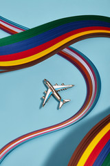 Closeup shot of shiny breastpin in view of silver airplane with blue insertions, isolated...