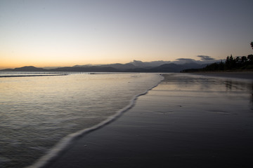 sunset on the beach with waves
