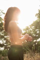 Portrait of a young brunette runner ready for the marathon. Model checks pulse with a smart watch