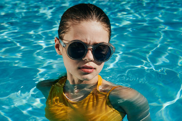 woman in sunglasses in swimming pool