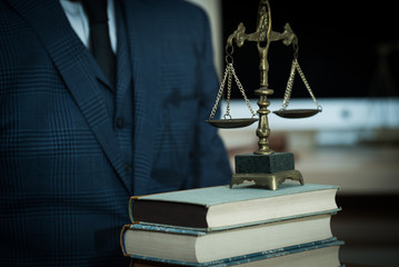 Lawyer businessman working or reading lawbook in office workplace for consultant lawyer concept.