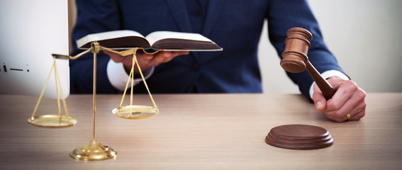 Lawyer businessman working or reading lawbook in office workplace for consultant lawyer concept.