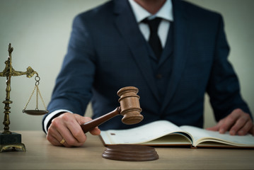 Lawyer businessman working or reading lawbook in office workplace for consultant lawyer concept.