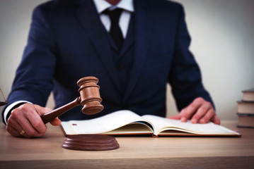 Lawyer businessman working or reading lawbook in office workplace for consultant lawyer concept.