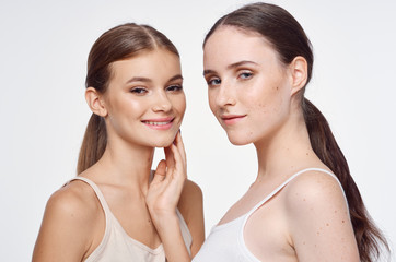 two young girls with perfec skin