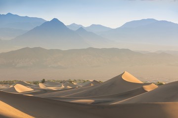 Fototapeta na wymiar Sand Dune Formations over beautiful sunrise in Death Valley National Park, California, USA Mesquite Flat Sand Dunes formations with amazing structure sand. America desert