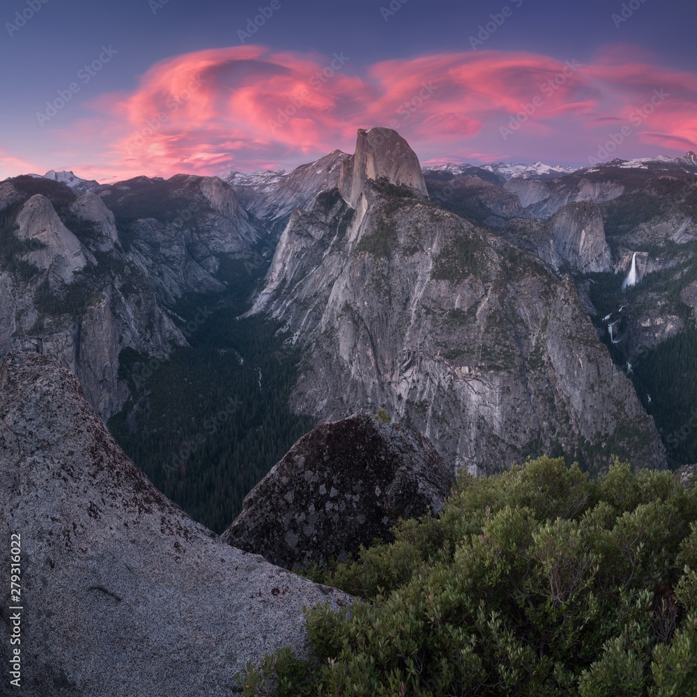 Wall mural half dome and yosemite valley in yosemite national park during colorful sunrise with trees and rocks