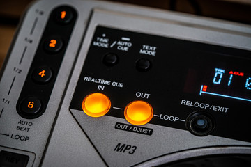 Closeup of 'Cue IN/OUT' buttons on a CD Player