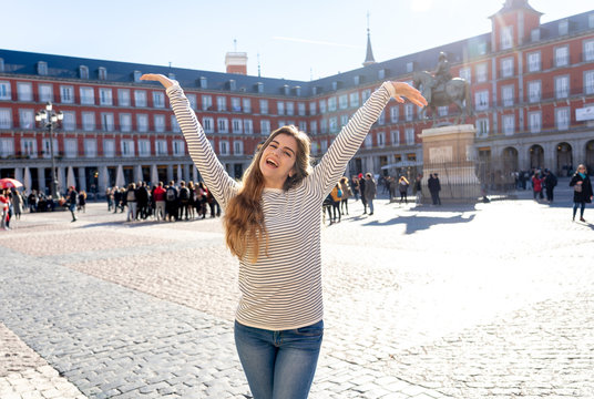 Attractive happy young woman enjoying spanish sightseeing in Madrid. In tourism in European city.