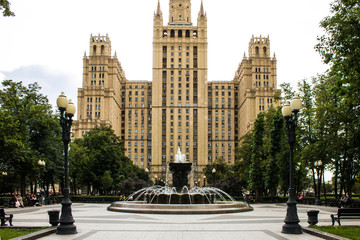 Obraz premium Fountain on the background of the historic brick high-rise cloudy summer day Moscow Russia