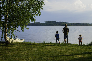 Father with two children fishing.