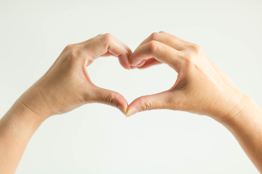 Hands display love sign by splice fingertips together to be heart frame.