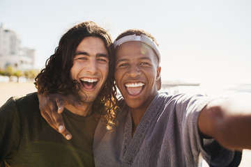 Cheerful friends making a selfie outdoors
