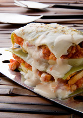 portion of lasagna on bamboo table