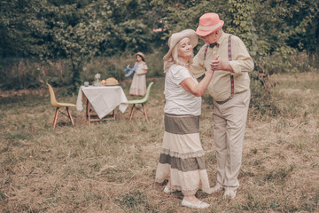 A grandfather with happy eyes looks grandmother in the eyes. Youth memories. The concept of a happy...