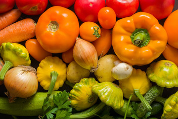 Summer vegetables of different colors. The alternation of colors in a rainbow. For salad or for a vegetable dish.