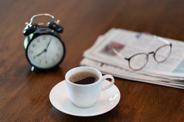 Hot coffee cup and vintage clock time at 8 o'clock in the morning