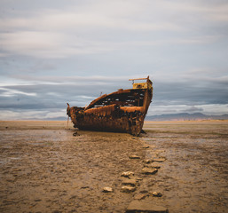 old fishing boat stuck on the beach