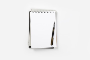 school notebook on a white background, spiral notepad on a table.
