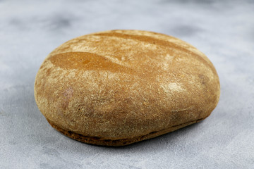 Fototapeta na wymiar country bread on grey background