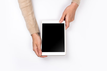 Closeup shot of  Woman's hands with perfect manicure  holding tablet, Empty display device. with clipping path.