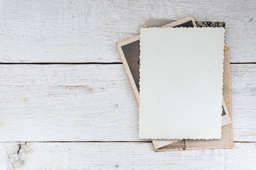 Old retro photos on wooden background. Blank background.