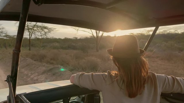 Woman on a safari trip in Masai Mara park, Kenya