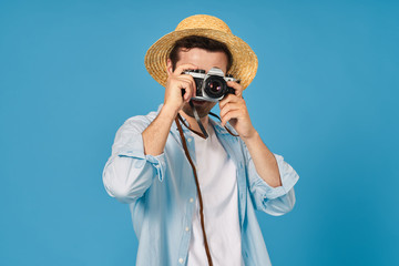 man in hat with camera on blue vacation background