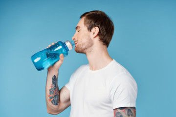 man drinking water on a blue background