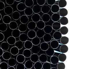 Stainless steel straws vertical abstract background. Metal pipes bundle side view decorative texture. Shiny metallic, aluminium hollow tubes in blue and violet colors backdrop for modern design