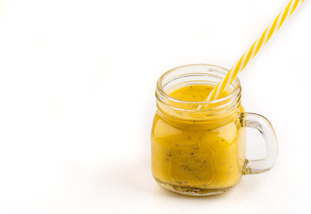 Smoothie with tropical fruits: mango, banana, avocado, chia seeds in a glass jar