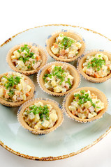Russian salad canape served green onions for catering. Top view banquet table with cold snacks iIsolated on white background. Party food concept.