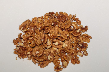 Heap kernels of walnut on a kitchen table. Concept of healthy vegan food.