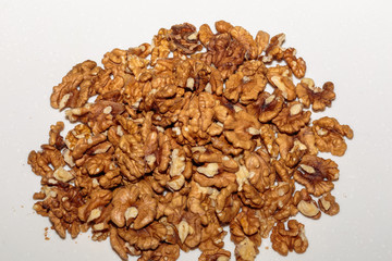 Heap kernels of walnut on a kitchen table. Concept of healthy vegan food.