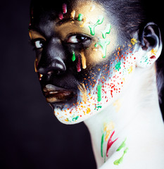 woman with creative makeup closeup like drops of colors, facepaint close up halloween