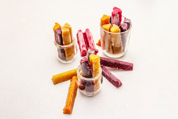 Frozen assortment of fruit purees in the form of sticks