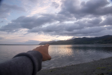 sunset on beach Hand pointing
