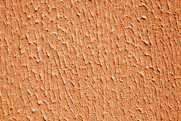 Plaster wall texture with interesting pattern in orange color.