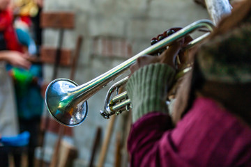 Fusion of cultural & modern music event. A trombone is seen close up, in the hands of a blurred musician, playing at a live music festival fusing traditional and native sounds , with copy space